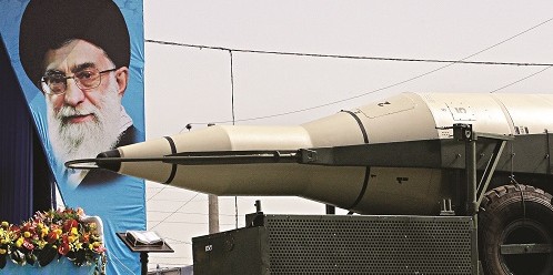 A missile is displayed by Iran's Revolutionary Guard, in front of a portrait of the Iranian supreme leader Ayatollah Ali Khamenei.