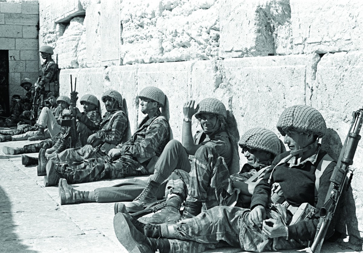 Israeli soldiers sit at the Western Wall, Judaism's holiest site, after capturing Jerusalem's Old City during the Six Day War, in June 1967. (AP Photo/Israeli Ministry of Defence,HO) 