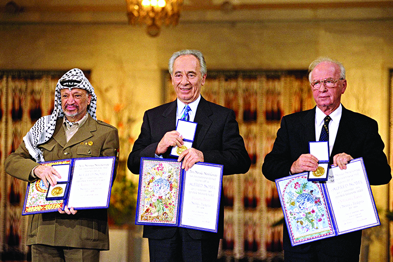 Yasser Arafat, Shimon Peres and Yitzhak Rabin with their Nobel Peace prizes. Image: Sa'ar Ya'acov for the Israel Government Press Office
