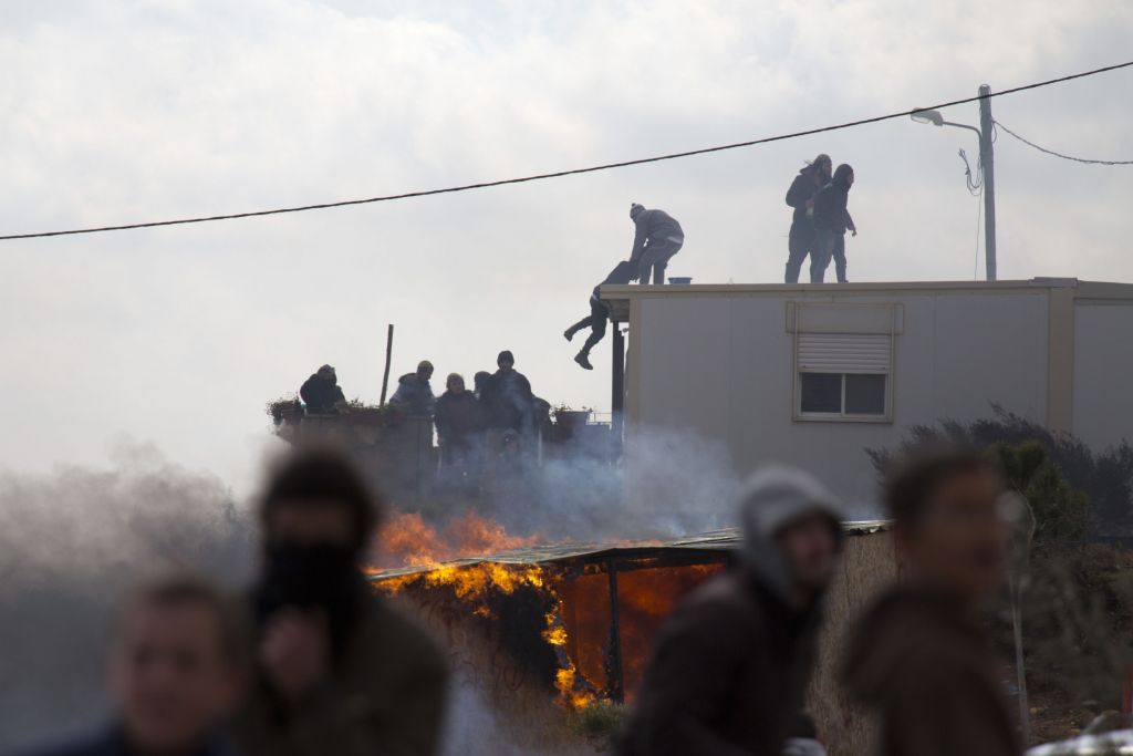 Settlers climb on top of a trailer in Amona outpost in the West Bank  (AP Photo/Ariel Schalit) 