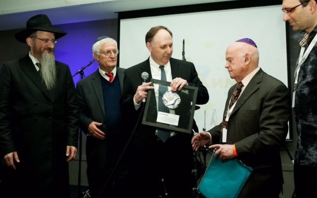 Holocaust survivor Ben Helfgott receiving his award.