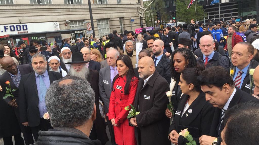Rabbi Hershel Gluck and Board of Deputies president Jonathan Arkush (second and third from left) at a vigil in Westminster to mark a week since terror. (Photo credit: Shomrim on Twitter) 