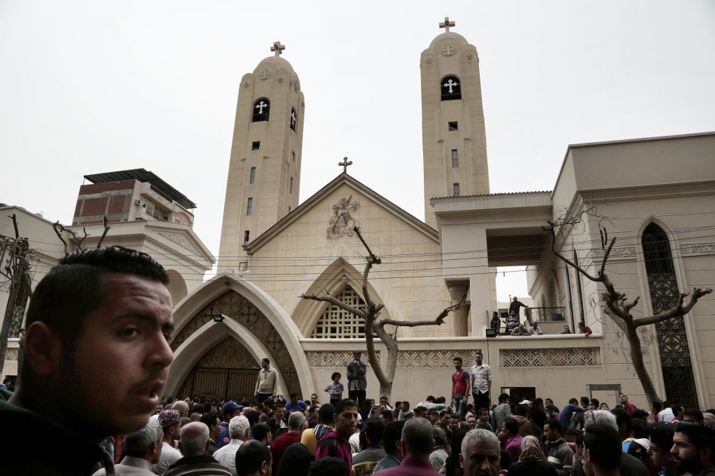 People gather outside the St. George's Church after a suicide bombing, in the Nile Delta town of Tanta, Egypt, Sunday, April 9, 2017. (AP Photo/Nariman El-Mofty) 