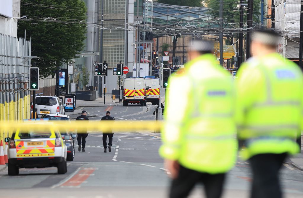 Police close to the Manchester Arena the morning after a suspected terrorist attack at the end of a concert by US star Ariana Grande left 22 dead. Photo credit: Peter Byrne/PA Wire 