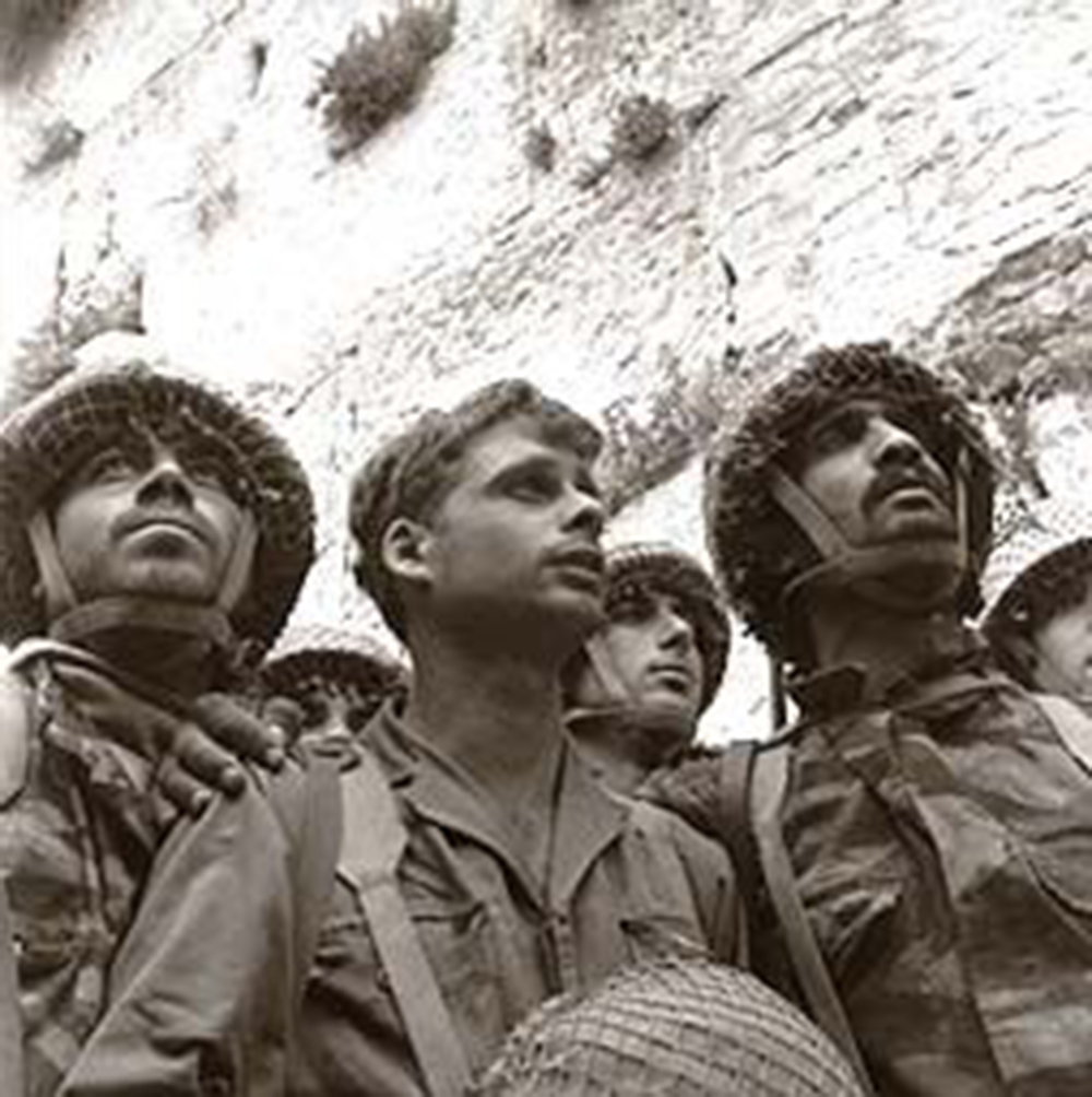 David Rubinger's famed photograph of IDF paratroopers at Jerusalem's Western Wall shortly after its capture. From left to right: Zion Karasenti, Yitzhak Yifat, and Haim Oshri.[a] 