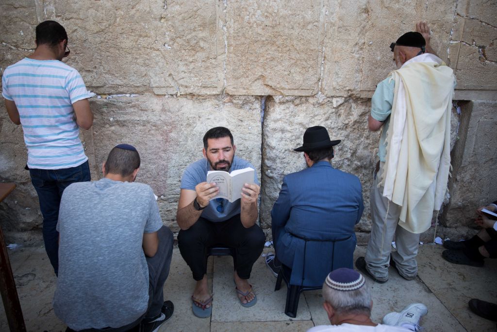 Jewish men pray as they gather for the ritual of Tisha B'Av at the Western Wall in the Old City of Jerusalem, Photo by: JINIPIX 