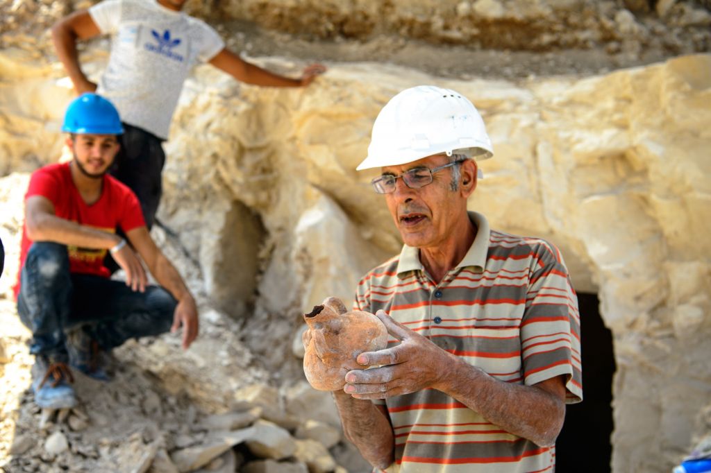 Employees of the Israel Antiquities Authorities (IAA) work during archaeological excavations in a newly discovered small cave at the Arab town of Reina in Galilee. The excavations at the ancient site uncovered a 2,000-year-old workshop for the production of stone vessels, including remains of chalkstone mugs and bowls.  Photo by: Gil Eliyahu - JINIPIX 