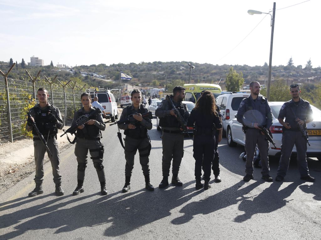Israeli police blocks the road to Har Adar settlement near Jerusalem after a Palestinian attacker opened fire at the entrance to the settlement killing three Israeli men and critically wounding a fourth. (AP Photo/Mahmoud Illean) 