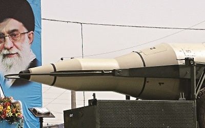 A missile is displayed by Iran's Revolutionary Guard, in front of a portrait of the Iranian supreme leader Ayatollah Ali Khamenei. (2013)