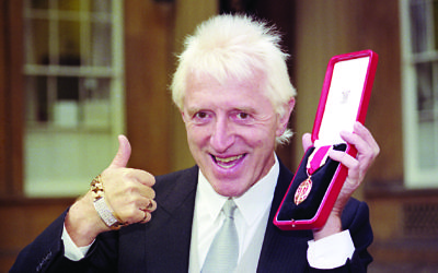 Savile after receiving his knighthood in 1990