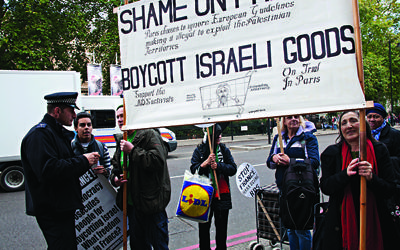 Pro-Palestinian protesters call for a boycott on Israeli goods in central London.