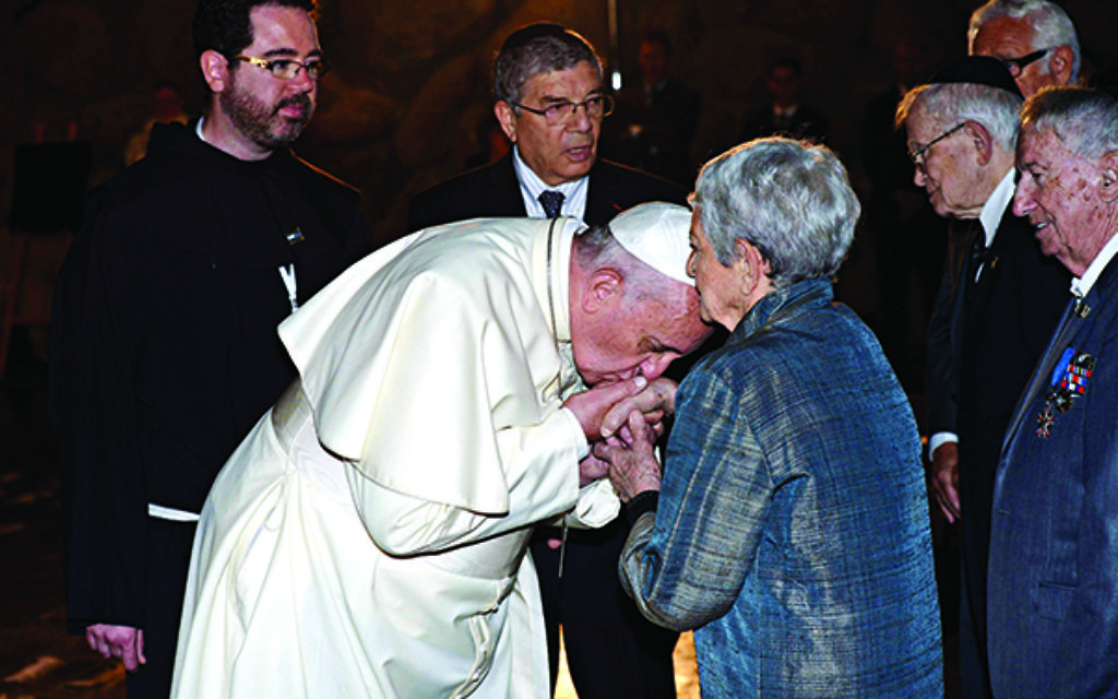Pope Francis kisses a Shoah survivor's hand at Yad Vashem.