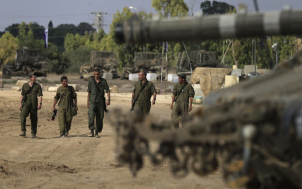 Israeli soldiers gather near the Israel and Gaza Strip border.