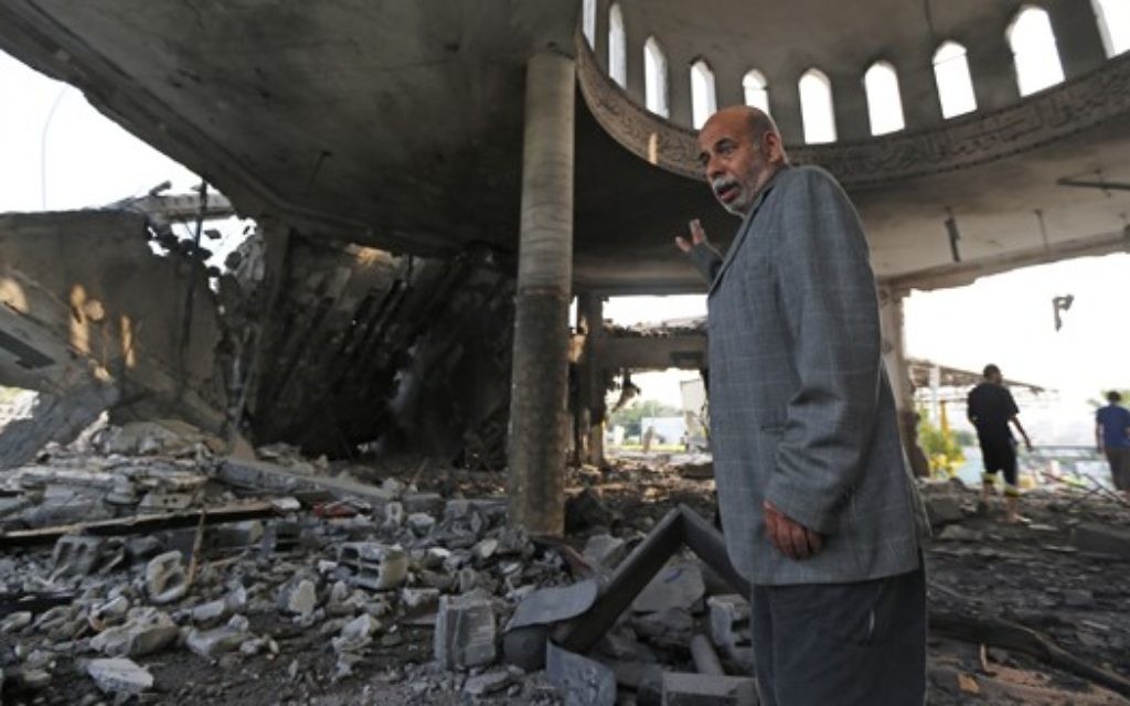 Palestinian Khaled Sharmi, 67, inspects the damage in the Al Aqsa Martyrs mosque destroyed by an overnight Israeli strike, in Gaza City.