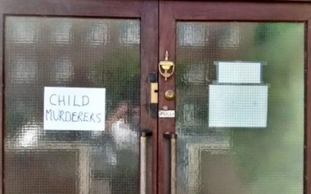 A sign saying 'child murderers' was posted on the doors of Kingston shul.