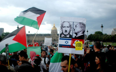Protesters wave Palestinian flags and hold placards during a pro-Palestinian demonstration.