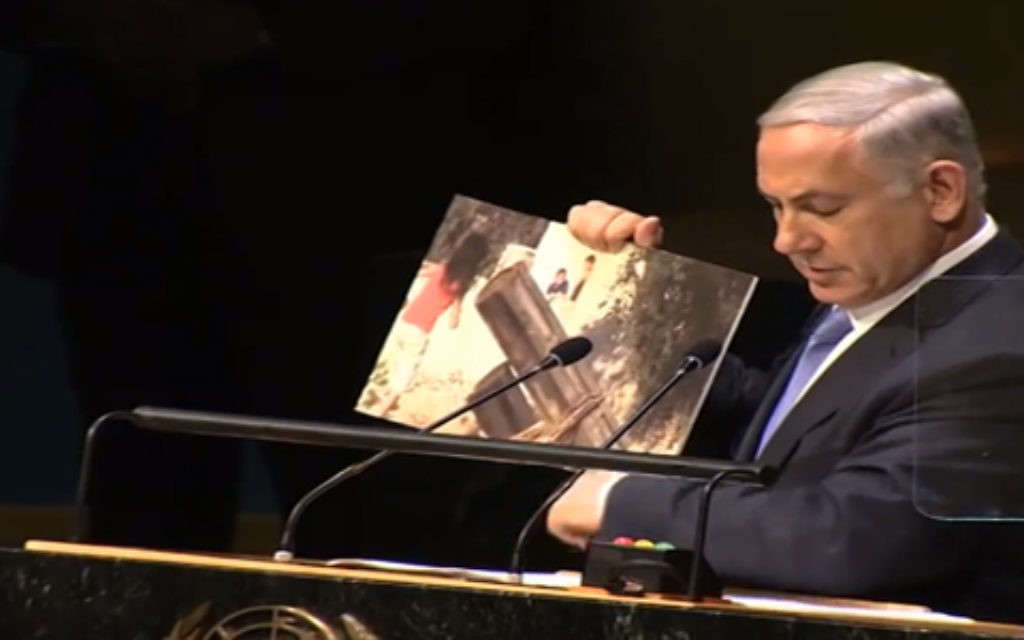 Netanyahu holding up pictorial assistance