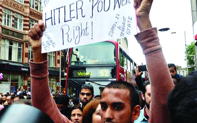 Hussain Yousef holding an anti-Semitic sign 'Hitler was right' in London, 2014