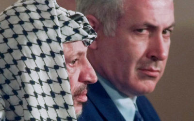 Israeli Prime Minister Benjamin Netanyahu, right, looks around PLO leader Yasser Arafat in 1996.