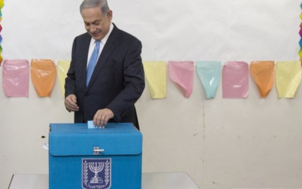 Israeli Prime Minister Benjamin Netanyahu casts his vote during Israel's parliamentary elections in Jerusalem, 2015.