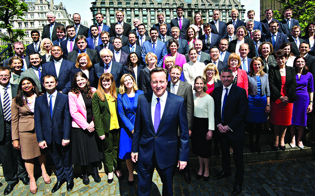 Prime Minister David Cameron (centre) poses for a group photo with newly elected Conservative MPs, at the Houses of Parliament, Westminster, London.