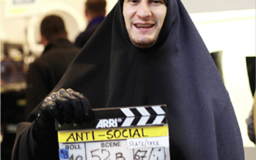 Dressed for work: Josh Myers disguised as a gang member in a burka on the set of his latest film, Anti-Social