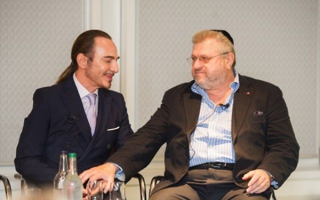 John Galliano (left) is consoled by Rabbi Barry Marcus during the emotional event.