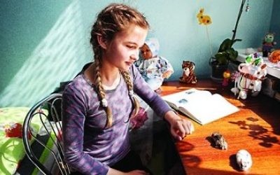 Valentina’s daughter, Yulia, 11, one of many internally displaced people in a temporary shelter. Yulia, pictured with her pets, wants to be a police officer