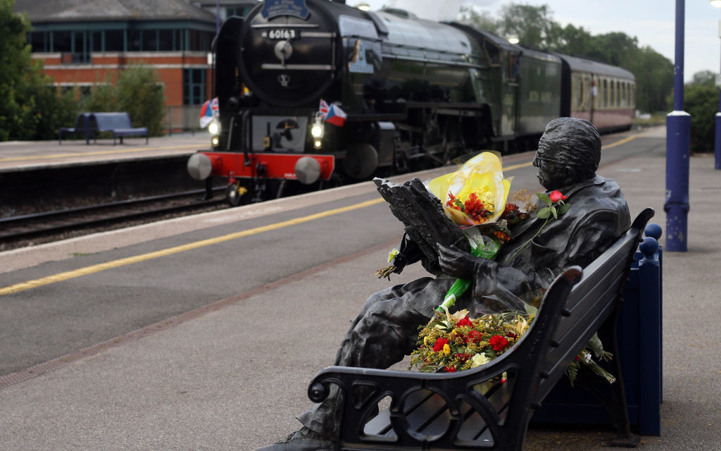 The locomotive Tornado made a special stop in Maidenhead, Berkshire, at the statue of Sir Nicholas Winton, in honour of the man who died last week aged 106. PRESS ASSOCIATION Photo. Picture date: Wednesday July 8, 2015. The British hero who saved hundreds of children by helping them flee the Nazis before the Second World War has received a special steam-powered tribute in his home town. The locomotive Tornado made a special stop in Maidenhead, Berks, tonight in honour of Sir Nicholas Winton, who died last week aged 106. Sir Nicholas was known as "Britain's Schindler" for organising eight trains to carry 669 mainly Jewish children from Nazi-occupied Czechoslovakia to London in 1939, fearing they would otherwise be sent to Holocaust concentration camps. The Tornado pulled the British leg of The Winton Train, which recreated the children's journey in 2009. Tonight, decked in Union flags and Czechoslovakian flags, it stopped for four and a half minutes during a scheduled journey from London to Bristol in Maidenhead station, where there is a statue of Sir Nicholas, as a mark of respect. See PA story DEATH Winton. Photo credit should read: Steve Parsons/PA Wire