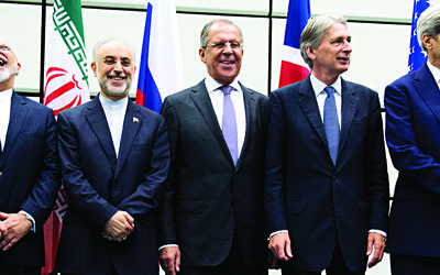 From left to right: European Union High Representative Federica Mogherini, Iranian Foreign Minister Mohammad Javad Zarif, Head of the Iranian Atomic Energy Organization Ali Akbar Salehi, Russian Foreign Minister Sergey Lavrov, British Foreign Secretary Philip Hammond and US Secretary of State John Kerry pose for a group picture at the United Nations building in Vienna, Austria, Tuesday, July 14, 2015. . (Joe Klamar/Pool Photo via AP)