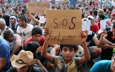 Thousands of migrants from Syria, Iraq, Afghanistan and Pakistan protest in central Europe over restriction of their movement after making the trip west.
