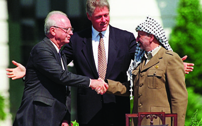 President Clinton presides over ceremonies marking the signing of the 1993 peace accord between Israel and the Palestinians on the White House lawn with Israeli Prime Minister Yitzhak Rabin, left, and PLO chairman Yasser Arafat, right. (AP Photo/Ron Edmonds)