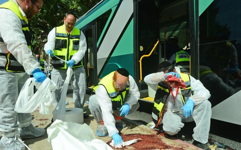 Paramedics attend the scene a 2015 terror attack in Jerusalem, after two Palestinians boarded a bus  armed with a gun and the other with a knife.  . Credit: Kobi Gideon/GPO ONLY