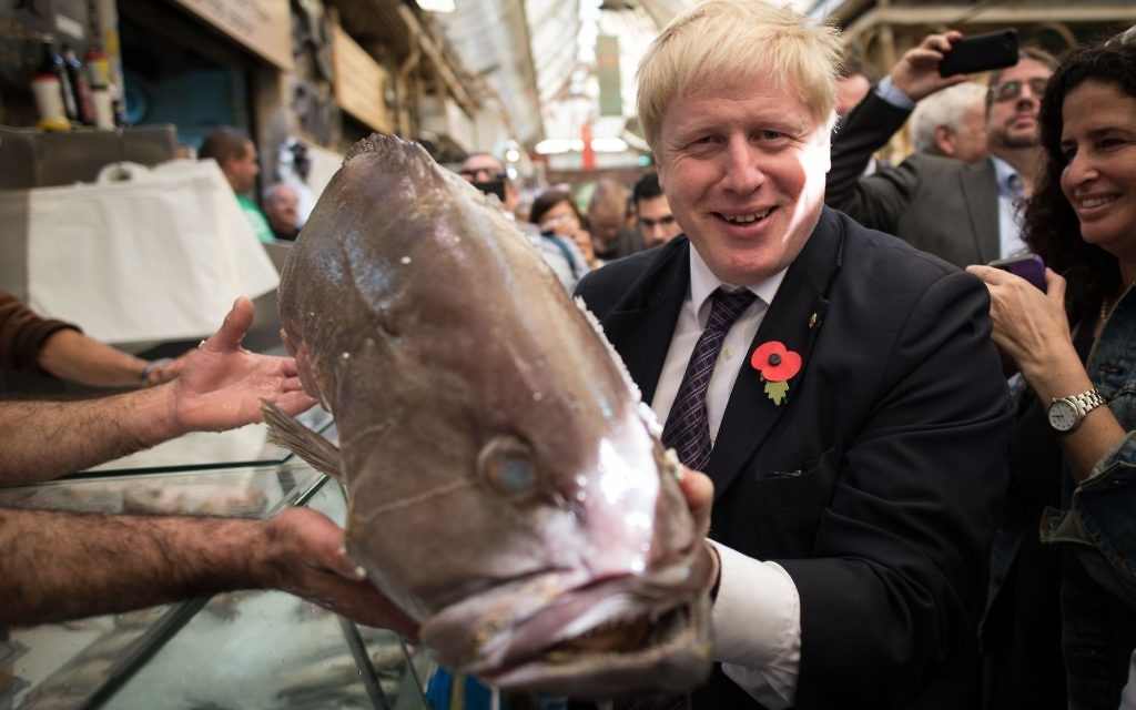 Mayor of London Boris Johnson is given a fish during his visit to Mahane Yehuda market in Jerusalem, Israel, where he met stallholders during the second day of a four day trade visit to the region. PRESS ASSOCIATION Photo. Picture date: Tuesday November 10, 2015. See PA story POLITICS Johnson. Photo credit should read: Stefan Rousseau/PA Wire