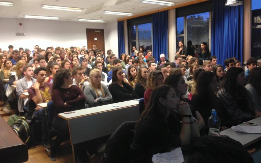A packed room of students listening to Ari speak