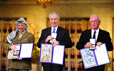 Yasser Arafat, Shimon Peres and Yitzhak Rabin with their Nobel Peace prizes. 

Image: Sa'ar Ya'acov for the Israel Government Press Office
