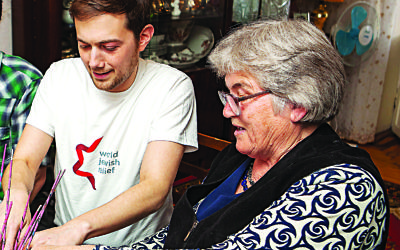 Richard Verber working with a local resident during A World Jewish Relief project in Ukraine