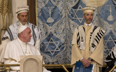 Pope Francis sits during his visit to the Great Synagogue of Rome, Sunday, Jan. 17, 2016. Pope Francis made his first visit to a synagogue as pope Sunday, greeting Rome's Jewish community in their house of worship as his two predecessors did in a show interfaith friendship at a time of religiously-inspired violence around the globe. (AP Photo/Alessandra Tarantino)