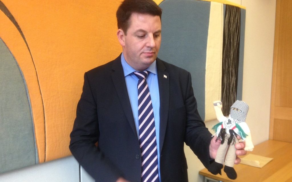 MP Andrew Percy, brandishing one of 4,000 "terror dolls" seized by Israeli authorities in December.