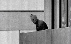 A masked member of Black September appears on a balcony during the terror attack A masked member of Black September appears on a balcony during the terror attack
