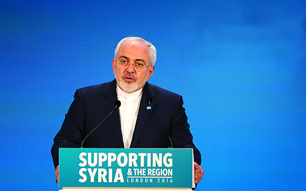 Iranian Foreign Minister Mohammad Javad Zarif makes a pledge during the second co-host chaired thematic pledging session for jobs and economic development during the 'Supporting Syria and the Region' conference at the Queen Elizabeth II Conference Centre in London, Thursday, Feb. 4, 2016. Leaders and diplomats around the world are meeting in London Thursday and pledging some billions of dollars to help millions of Syrian people displaced by war, and try to slow the chaotic exodus of refugees into Europe. (AP Photo/Matt Dunham, Pool)