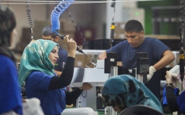 Employees work at a SodaStream factory built deep in Israel's Negev Desert next to the city of Rahat, Israel