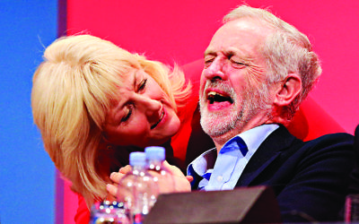 Labour leader Jeremy Corbyn laughs next to delegate Jennie Formby at the party's 2016 conference in Brighton.