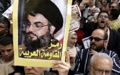 Hezbollah's leader Hassan Nasrallah's portrait is held up at a rally