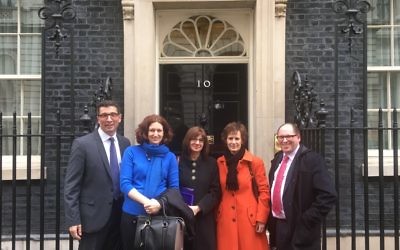 Social care leaders pose outside the iconic entrance to 10 Downing Street before their summit