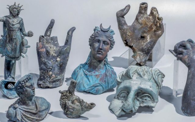 The Caesarea finds include well preserved bronze candles decorated with a likeness of the Roman Sun god Sol, a statue of the Moon goddess Luna, a candle in the form of an African slave's head and pieces of a vessel for carrying water.