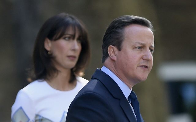The morning after: David Cameron with his wife Samantha on the doorstep of 10 Downing Street on Friday.