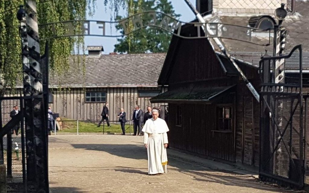 Pope Francis entering Auschwitz I camp through 'Arbeit macht frei' gate.