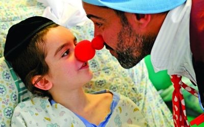 Red nose day takes on a whole new meaning for this youngster as he interacts with the medical clown (Photos: Avi Hayun & Yaffa Judah)