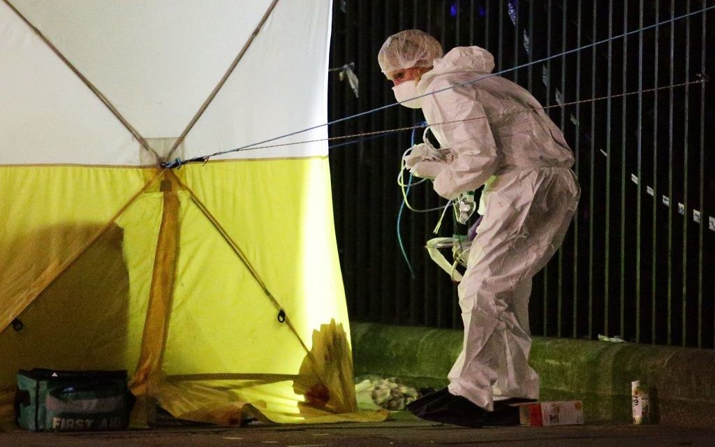 A police forensic officer at work in Russell Square after a knife attack in which a woman in her 60s was killed and five people were injured.